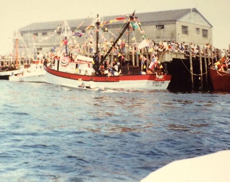 Blessing eileen white boat with red stripe at dock